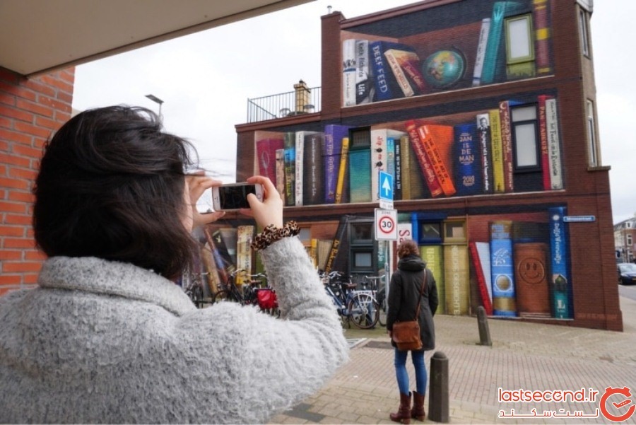 هنرمندان خیابانی، یک ساختمان معمولی را به یک قفسه کتاب دیدنی تبدیل کردند