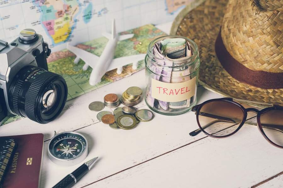 Collecting-money-for-travel-with-accessories-of-traveler.jpg